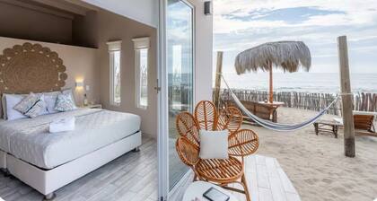 Nice bungalow on the beach, in front of the warm and calm sea.