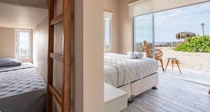 Nice bungalow on the beach, in front of the warm and calm sea.
