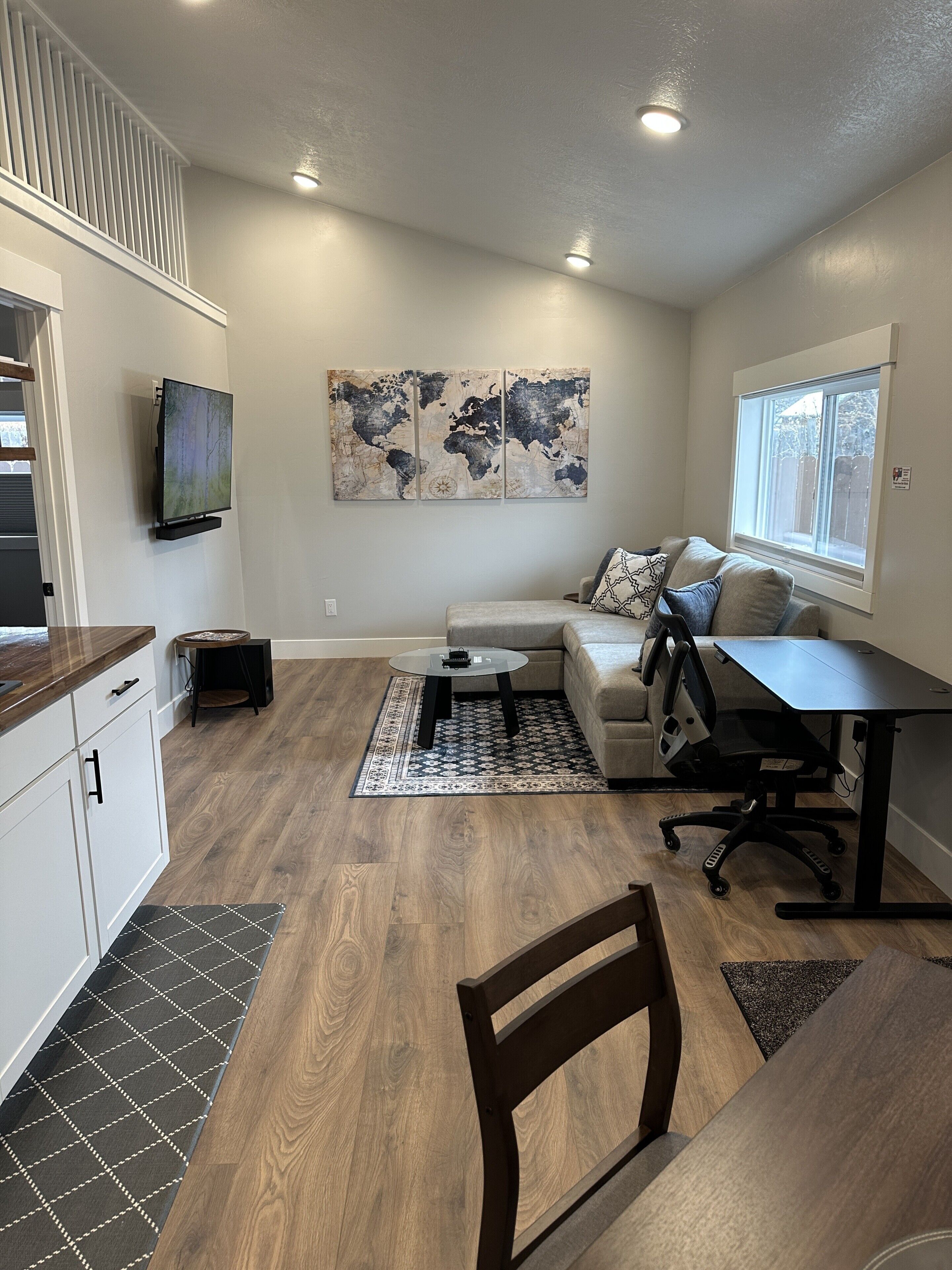 A modern living space with a kitchen, dining area, and seating area.