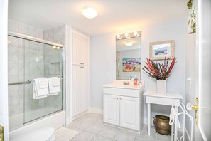 A single vanity & glass shower/tub combo await in the second floor bathroom - 4 BDR w/ Private Hot tub, Backyard and Deck! (Wells)
