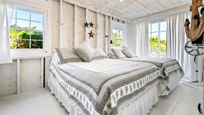A bedroom with a large bed, two windows, and a ceiling fan. - Near Crescent + Wells Beach • Firepit • Sleeps 10 (Wells)