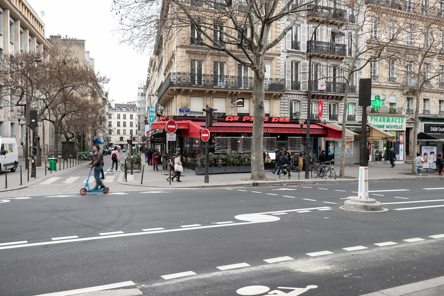 A street intersection with a café and pharmacy.