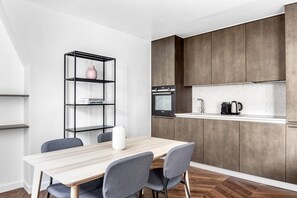 Enjoy cooking in this well-equipped kitchen with an oven, coffee maker, and dining table for four.