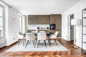 Enjoy meals in the kitchen with an oven and microwave, and dine at the dark wood table with white chairs.