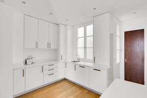 Enjoy cooking in this well-equipped kitchen with a sink and ample natural light.