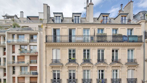 A multi-story building with balconies, large windows, and a classic architectural style. - Blueground | Pigalle, furnished, nr opera (Paris)