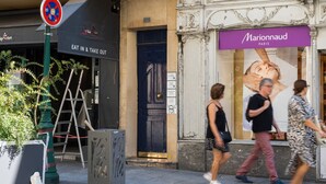 A street with a black awning, a blue door, and a large advertisement for 'Marionnaud Paris'. - Blueground | Montorgueil, intercom, nr Les Halles (Paris)