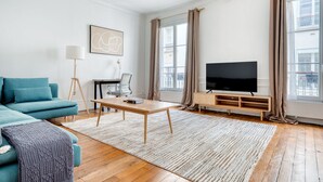 A modern living room with a sofa, coffee table, and TV.