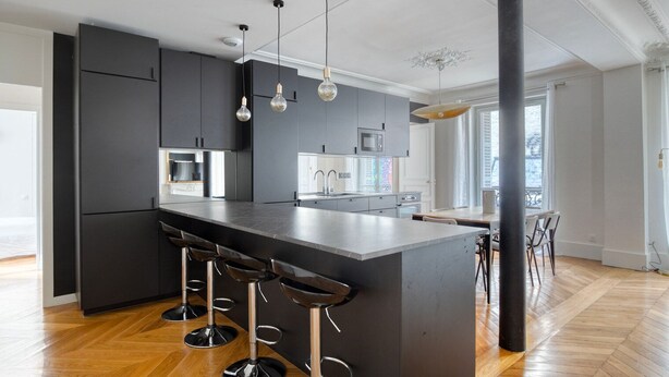 A modern kitchen with a central island, bar stools, and pendant lighting. - Blueground | Saint Georges, nr Palais Garnier (Paris)
