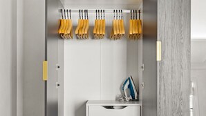 A modern kitchen with a white countertop, a built-in oven, and a hanging rack with knives. - Blueground | Trocadero, courtyard, nr museums (Paris)