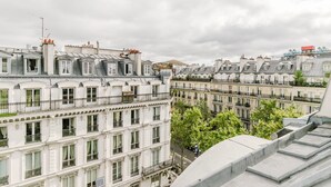 A row of classic European-style buildings with uniform architectural design, featuring multiple balconies and a consistent window pattern. - Blueground | Les Halles, close to Eiffel Tower (Paris)