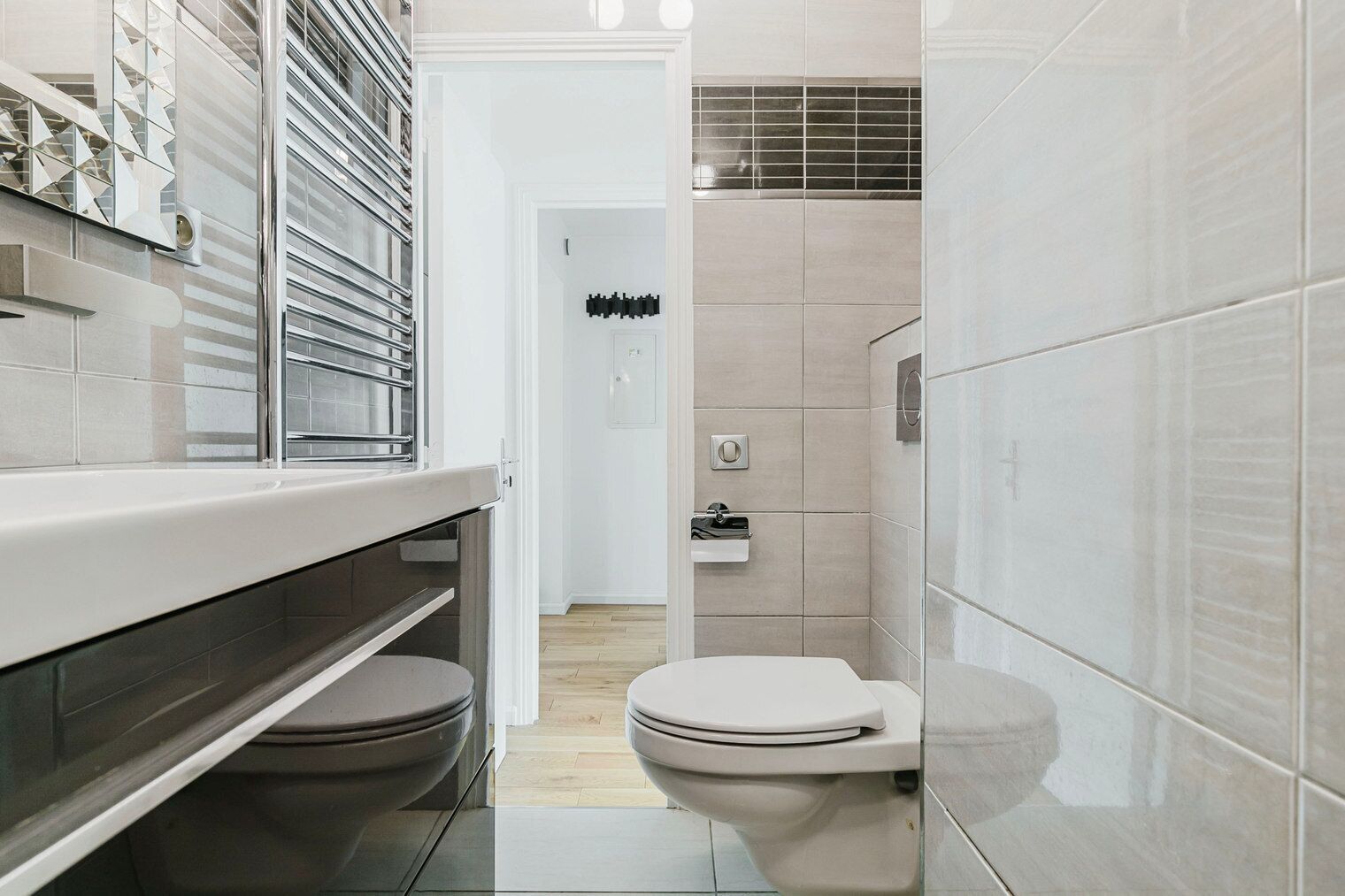A modern bathroom with a toilet, a sink, and a shower area.