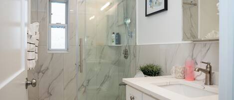 Shower, hair dryer, towels, shampoo