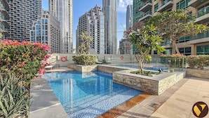 A rooftop pool with a view of high-rise buildings.