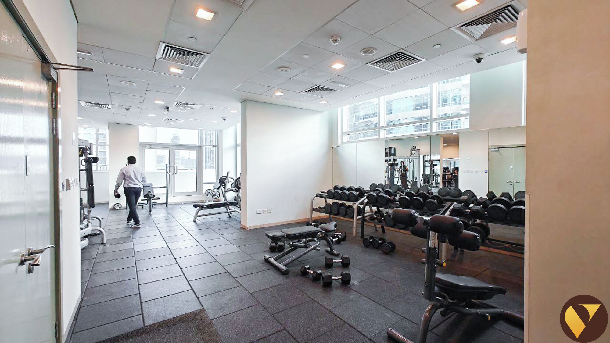 A gym with various exercise equipment, including dumbbells and weight machines.