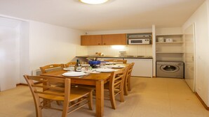 A compact kitchen with wooden cabinets, a microwave, and a washing machine. - Holiday home for 6 people with balcony (Val Cenis)
