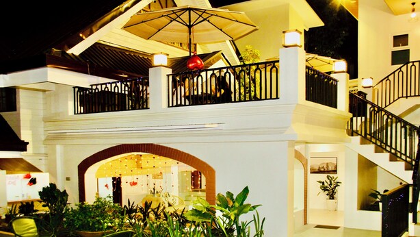 A multi-level building with a covered outdoor area, a staircase, and a balcony with a railing. - Hidden Oasis Resort (Gingoog)
