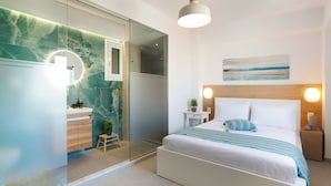 A modern bedroom with a bed, bedside table, and a nightstand.