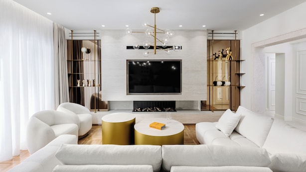 A modern living room with a large flat-screen TV, a gold-framed chandelier, and a white sofa set. - 4bd Ensuite Luxury Residence Kolonaki, Apartment (Athens)