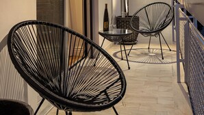 A balcony with two black wire-framed chairs, a small table, and a potted plant. - 4bd Ensuite Luxury Residence Kolonaki, Apartment (Athens)