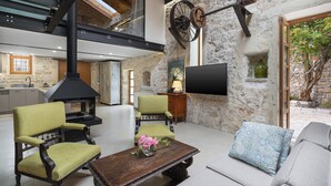 Villa – deluxe, bassengutsikt | Oppholdsområde | Flatskjerm-TV og peis
