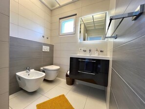 Regadera, secadora de cabello, bidet, toallas 