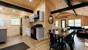 A wooden cabin interior with a kitchen, dining area, and living space. - The Mont Haus- WOOD FIRED SAUNA - Minutes to Mt. Snow and Stratton! (Wardsboro)