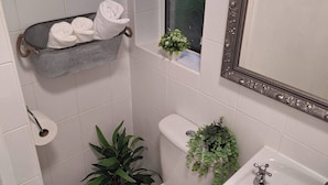 A bathroom with a toilet, sink, and a metal bucket with towels. - Ouston Oasis, Beamish (Chester-le-Street)