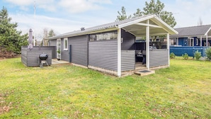 A single-story house with a covered patio area and a barbecue grill. - 4 Star Holiday Home in Hovborg (Hovborg)