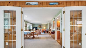A cozy interior with a dining area, kitchen, and a living space. - Lake Winnipesaukee Waterfront Home Private Beach Dock Sleeps 10 Sunset Views (Moultonborough)