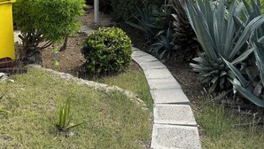 A yellow building with a covered patio area. - Diamond in Paradise-Hear the waves, feel the breezes from this 3 bedroom villa! (Christiansted)