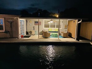 A house with a swimming pool, a covered patio with outdoor furniture, and a garage. - Happy OURS 206–Pool Near Beach–Sleeps 6 (Panama City Beach)