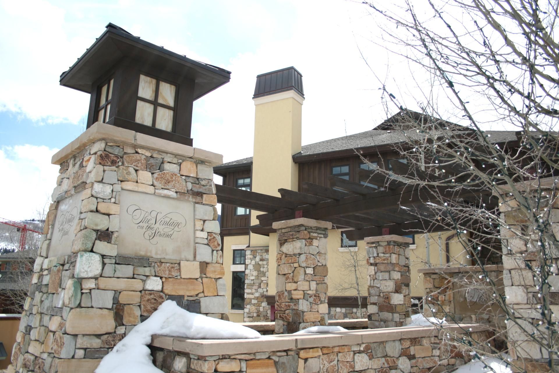 A stone building with a stone tower and a wooden deck.