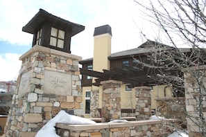 A stone building with a stone tower and a wooden deck.
