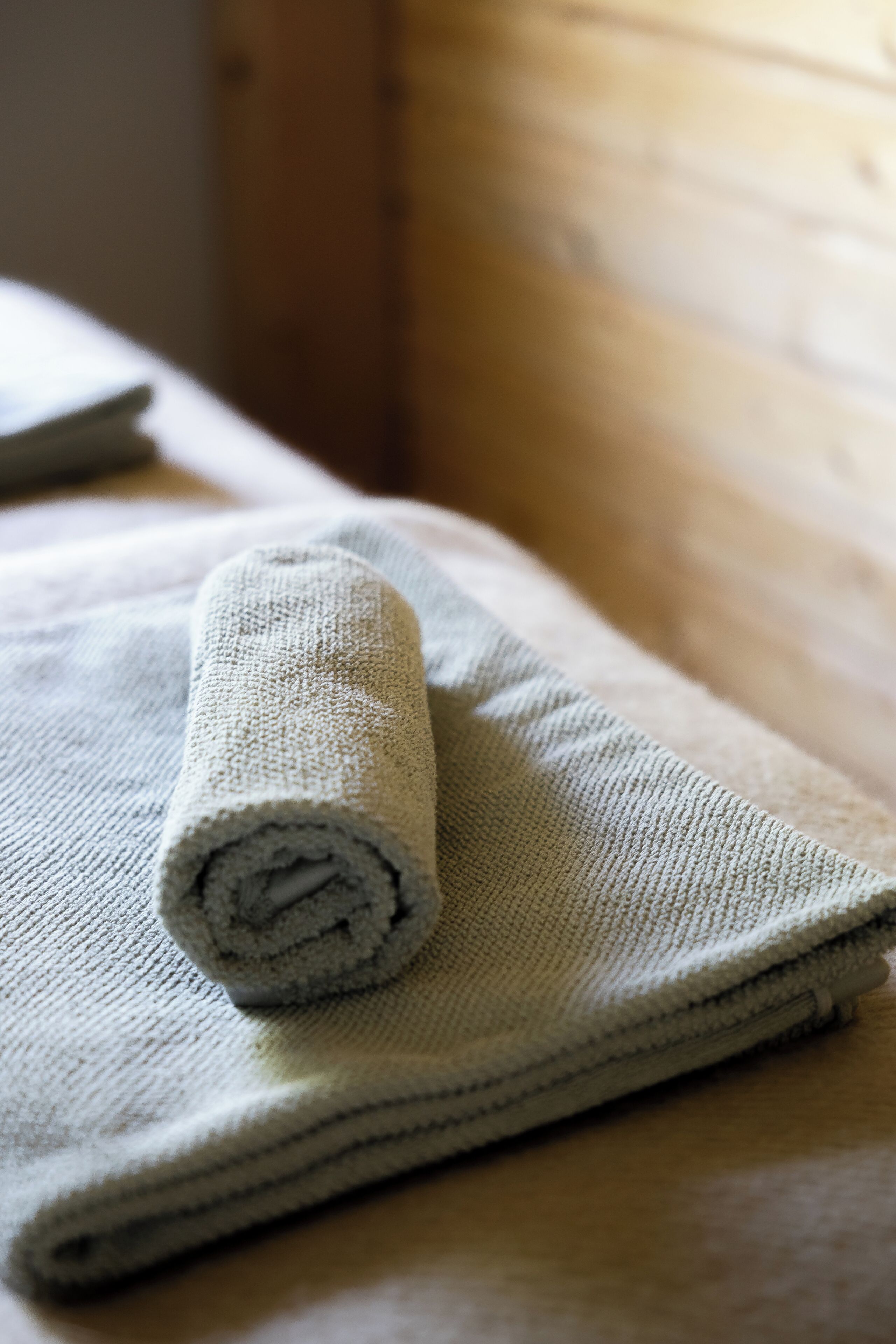 A rolled towel on a flat surface.