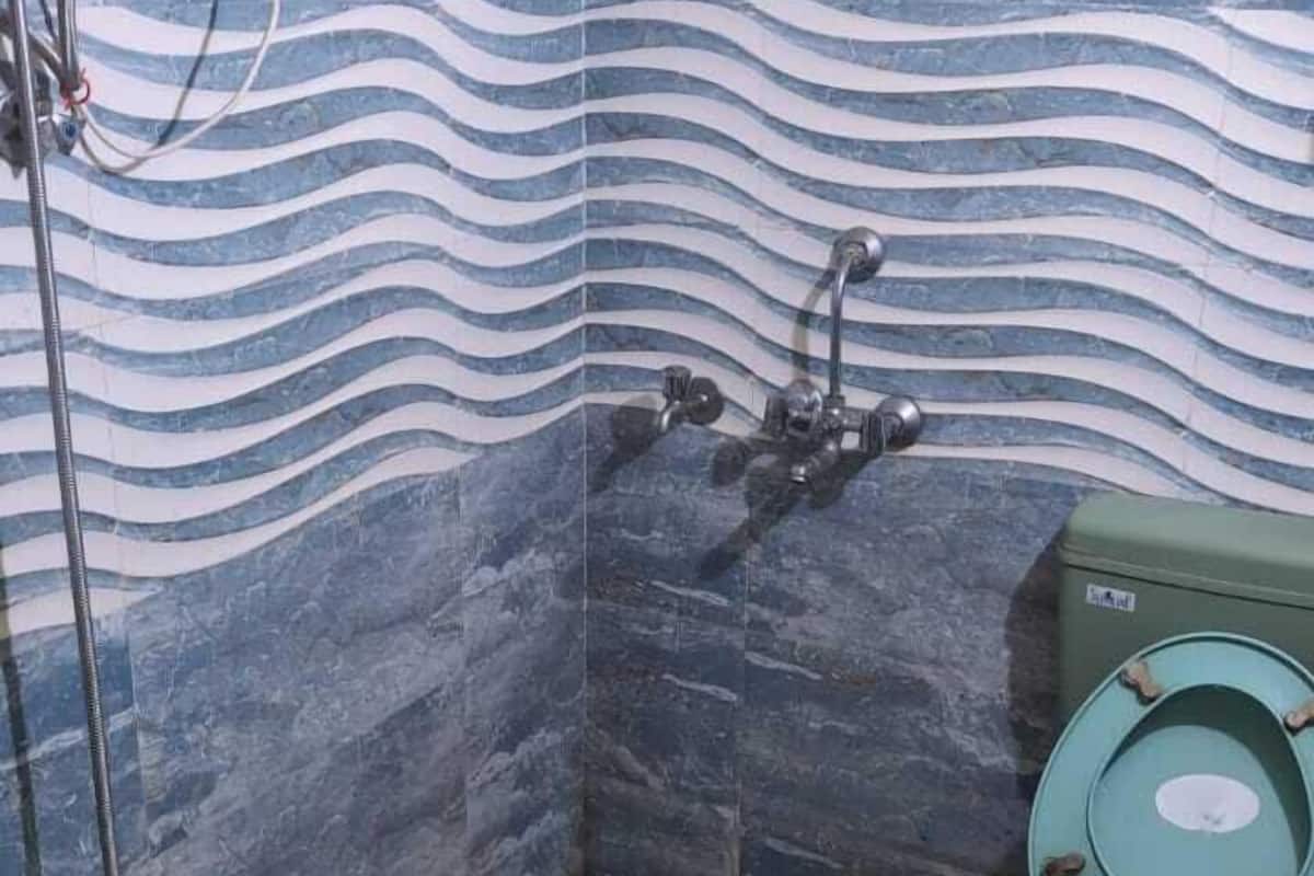 A bathroom with a shower, toilet, and sink.