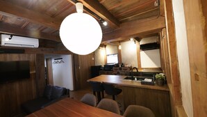 A wooden interior with a dining area, kitchen, and seating space. - FR1 Kominka hotel Fukunokura (Nishiaizu-machi)