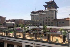 A hotel with a traditional architectural style, featuring a prominent tower and multiple windows. - Baiyangdian Weinan Hotel (Anxin)