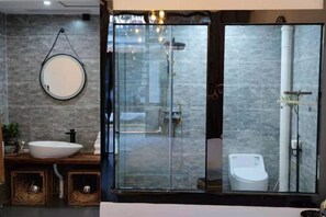 A modern bathroom with a glass-enclosed shower, a round mirror, and a white sink. - Baiyangdian Weinan Hotel (Anxin)