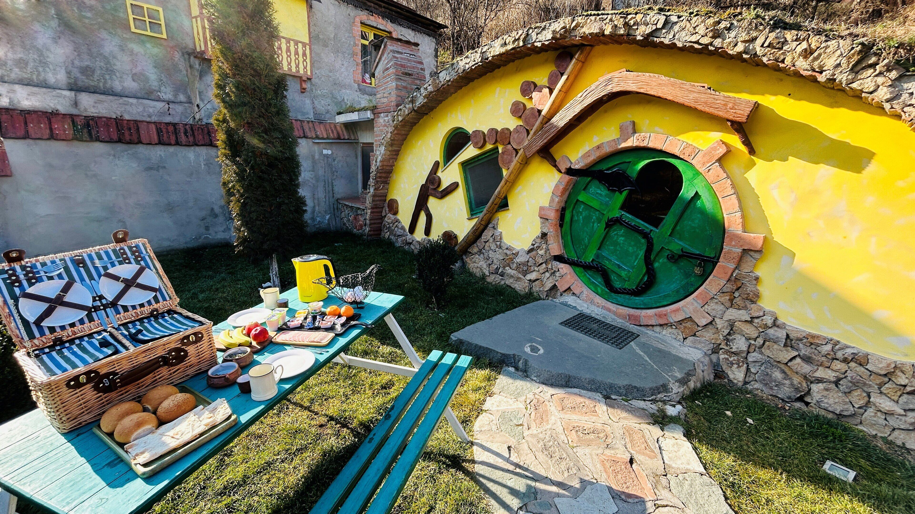 A Hobbit-style house with a round door and a small window.