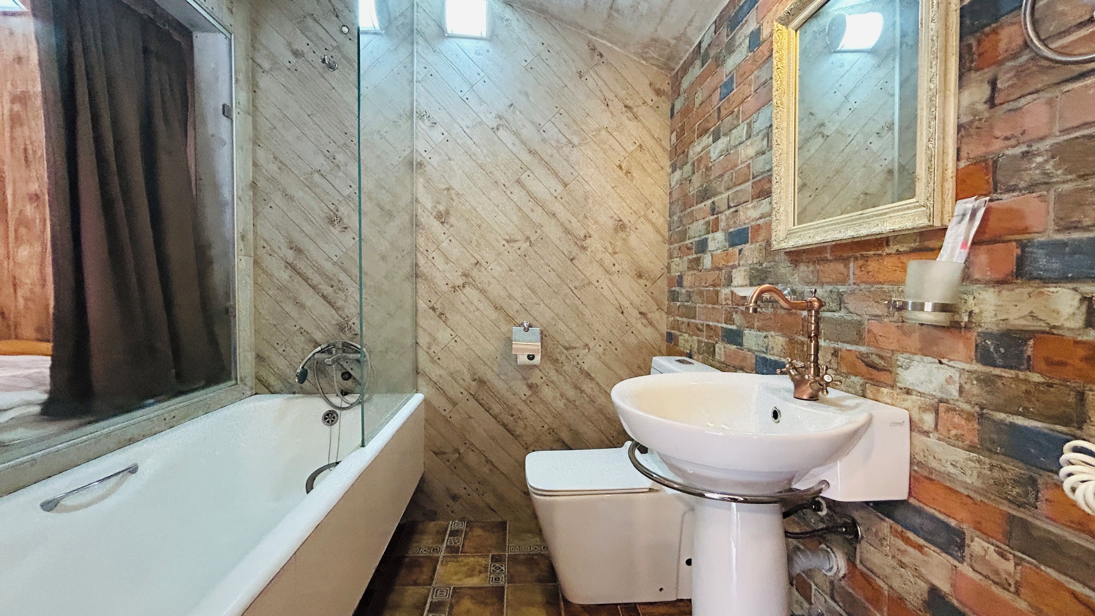 A bathroom with a bathtub, a sink, and a toilet. The walls are made of brick and marble.