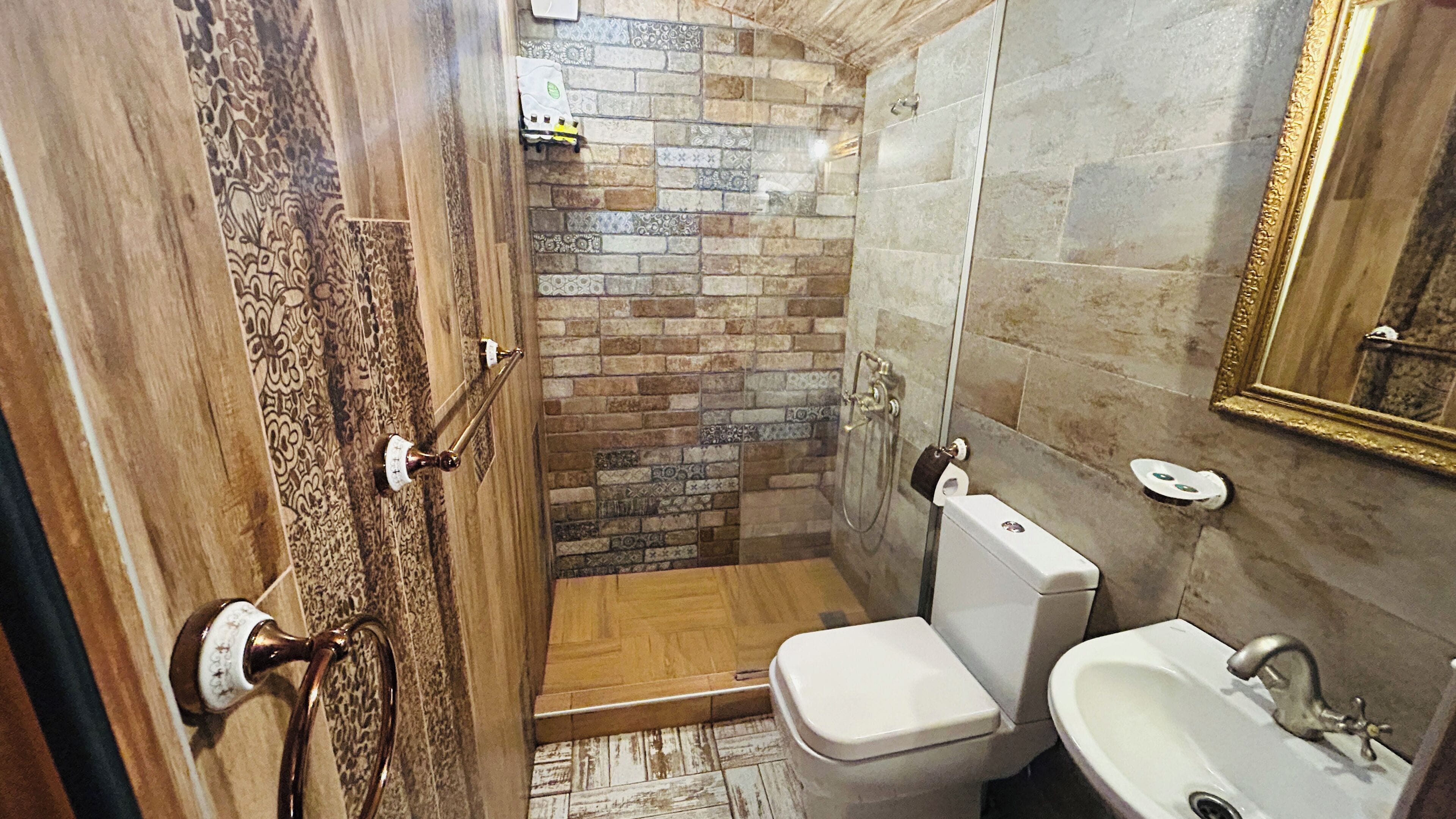 A bathroom with a shower, toilet, and sink.