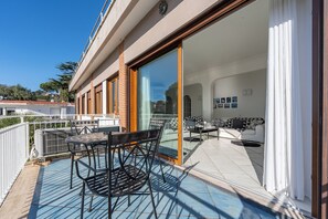 Relax on the patio with a round table and comfortable seating for four, surrounded by a clear view of the sky and landscape.