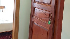 A wooden door with a keyhole and a small lock. - Provence: Crossing city apartment, quiet, very bright, terrace. 2 stars. (VALREAS)