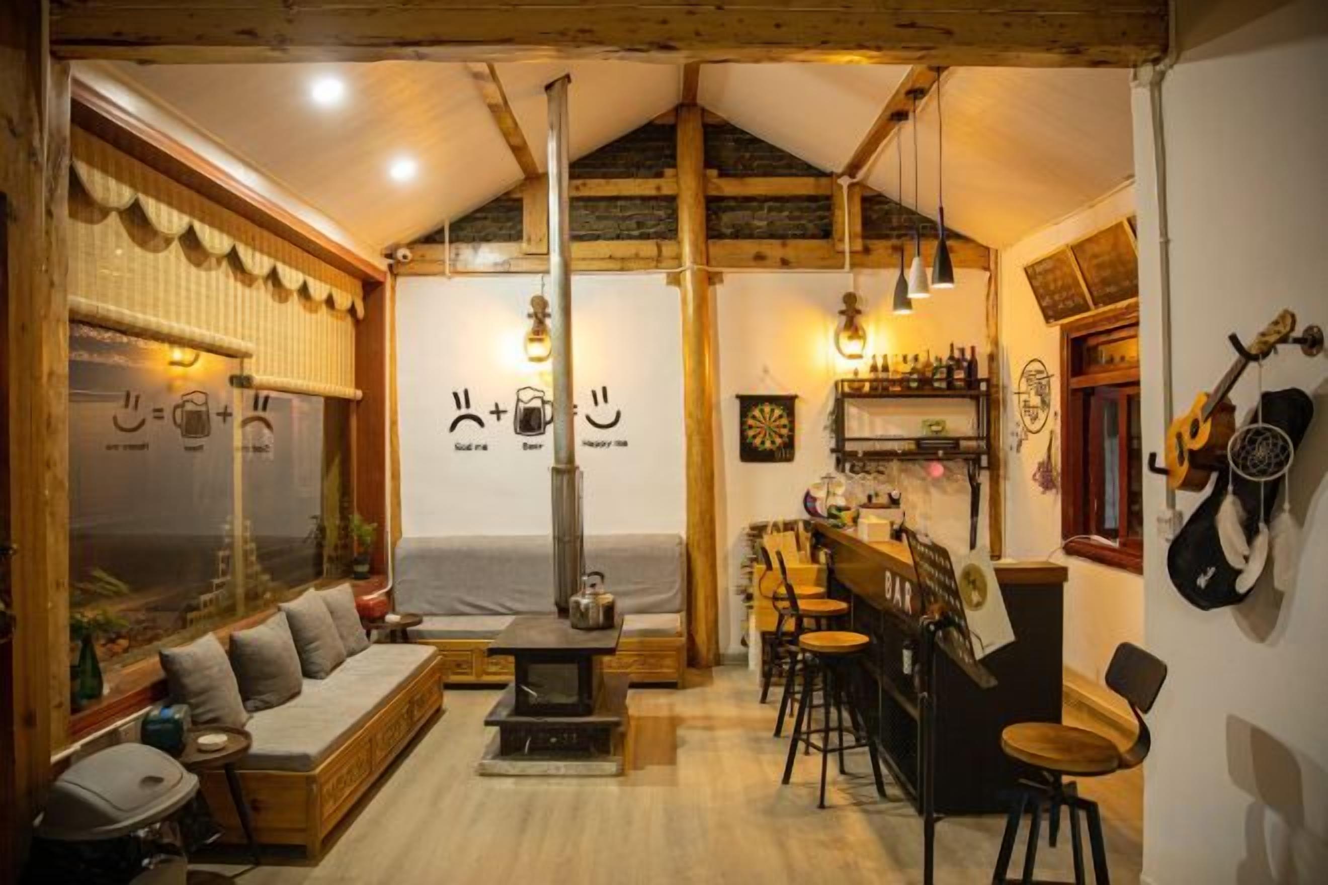 A cozy interior with a sofa, a bar area, and a fireplace.