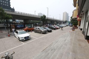 A parking lot with multiple cars and a pedestrian walkway. - Taiyuan Water Conservancy Building Finance University North Campus Store (Taiyuan)