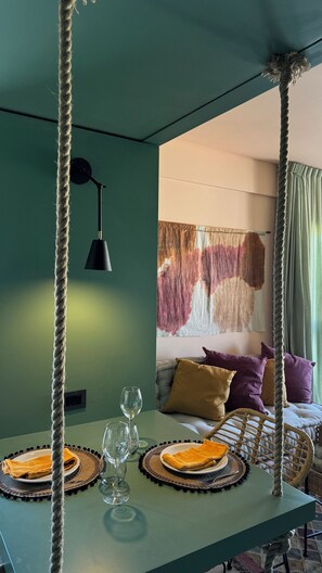 Relax in style with a unique rope swing, a comfortable bed, and a stylish table setting.