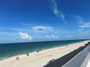 A beach view with a clear sky, sandy beach, and ocean. - Family size condo one block from beautiful Jax beach. Location,location,location (Jacksonville Beach)