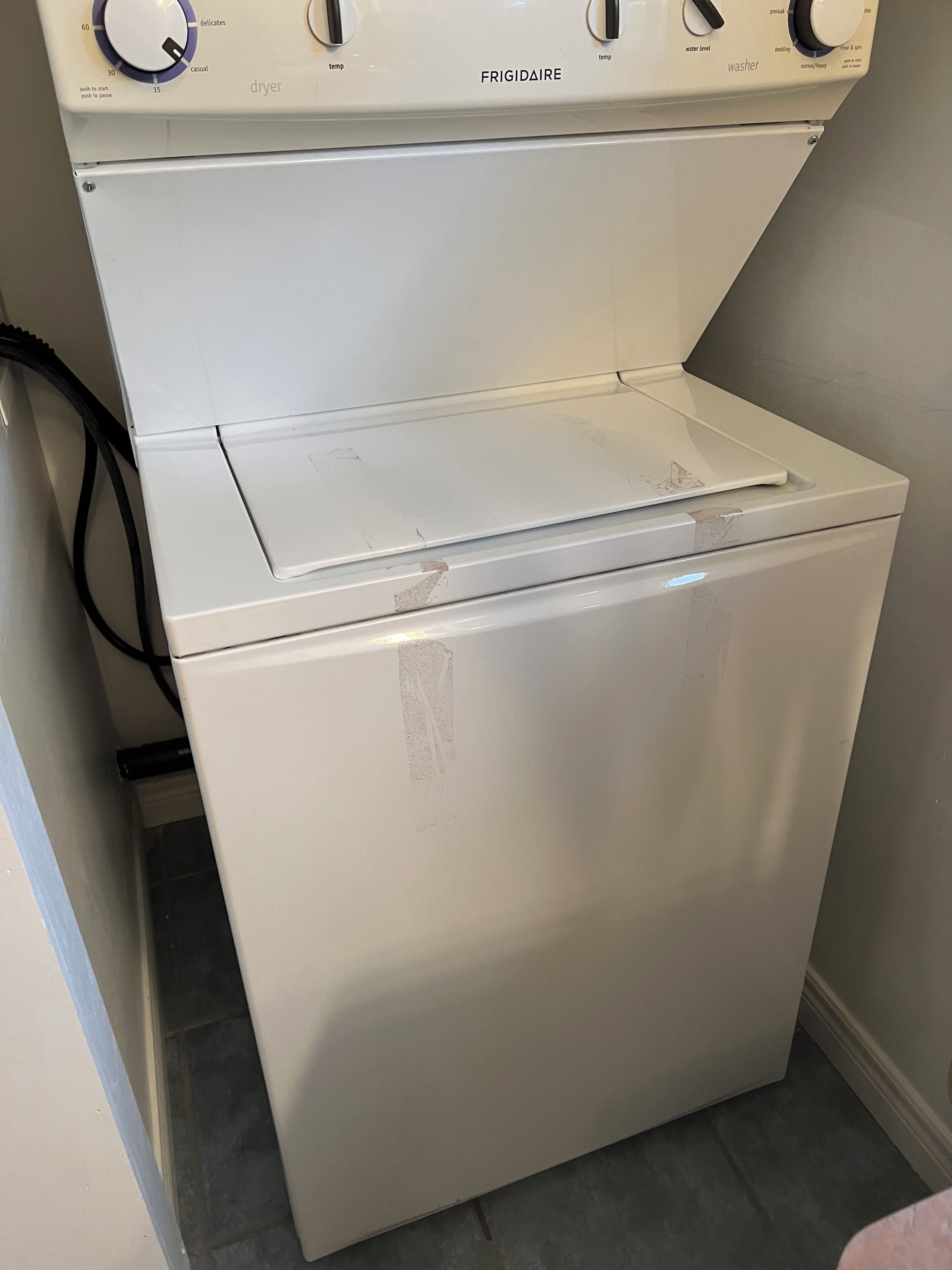 A white dryer with a control panel above it.