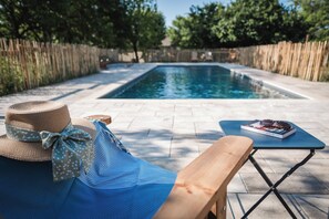 Seasonal outdoor pool, open 9:00 AM to 9:00 PM, pool umbrellas